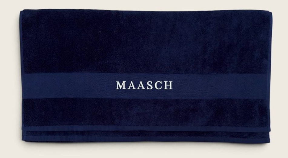 MAASCH towel in navy, folded with the woven band